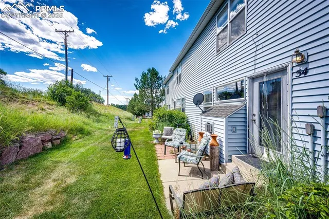 a view of a house with backyard and sitting area