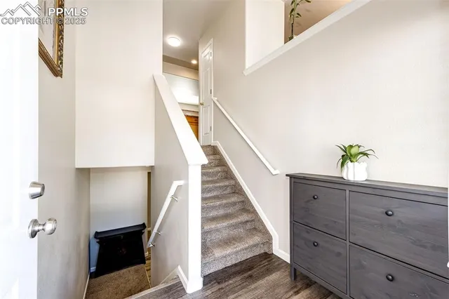 a view of entryway and hall with wooden floor