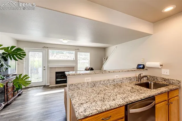 a kitchen with a stove and a wooden floor