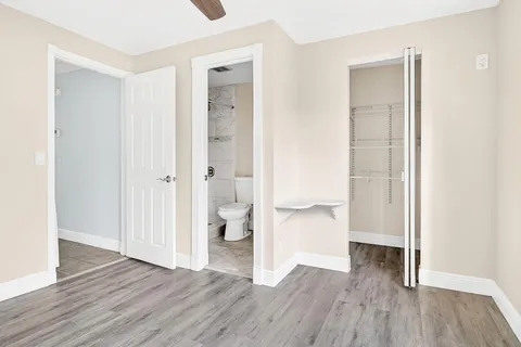 a bathroom with a sink toilet vanity and shower