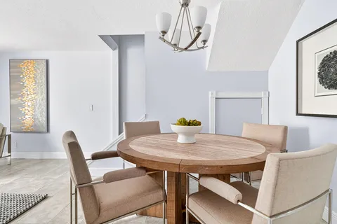 a view of a dining room with furniture and window