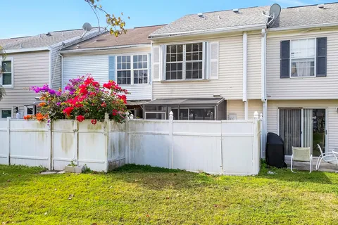 an aerial view of residential house with yard and swimming pool