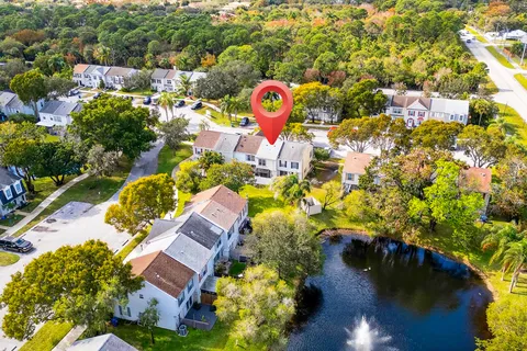 an aerial view of residential houses with outdoor space and swimming pool
