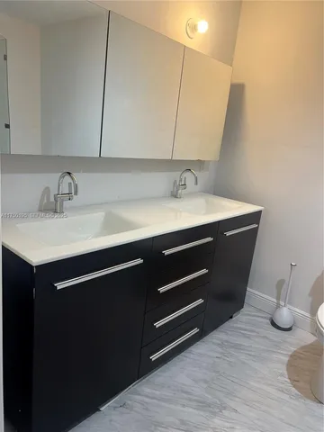 a kitchen with a sink and a refrigerator