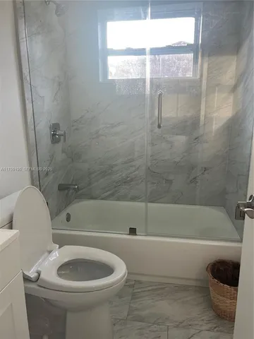 a bathroom with a toilet and a bathtub