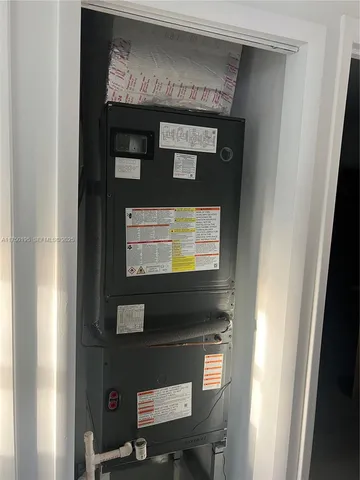a view of a hallway with wooden floor and a glass door