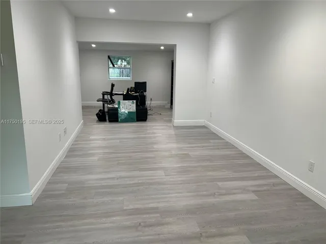 a room with wooden floor and furniture