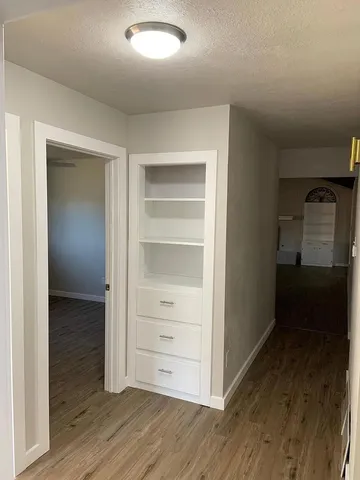 a view of walk in closet with empty racks