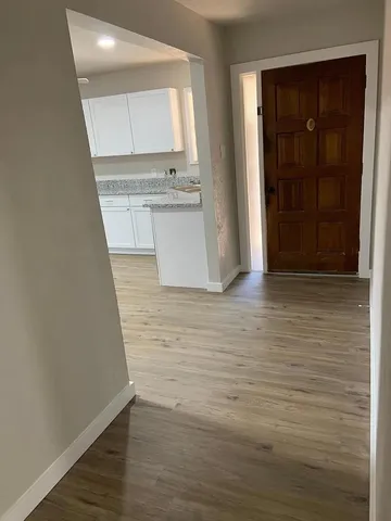a view of a kitchen with wooden floor and a sink