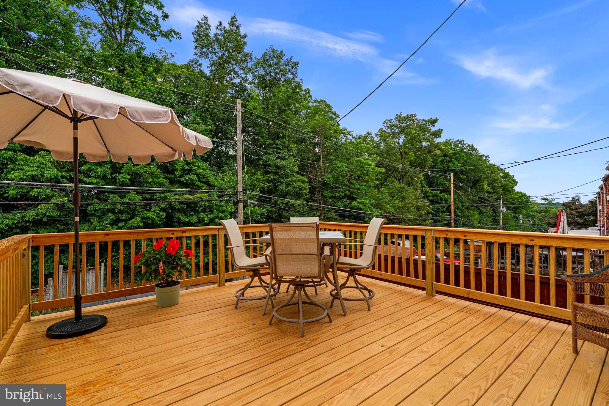 1126 Elm Road Baltimore, MD 21227 - Photo 6 of 30 Kitchen leads to expansive deck facing trees