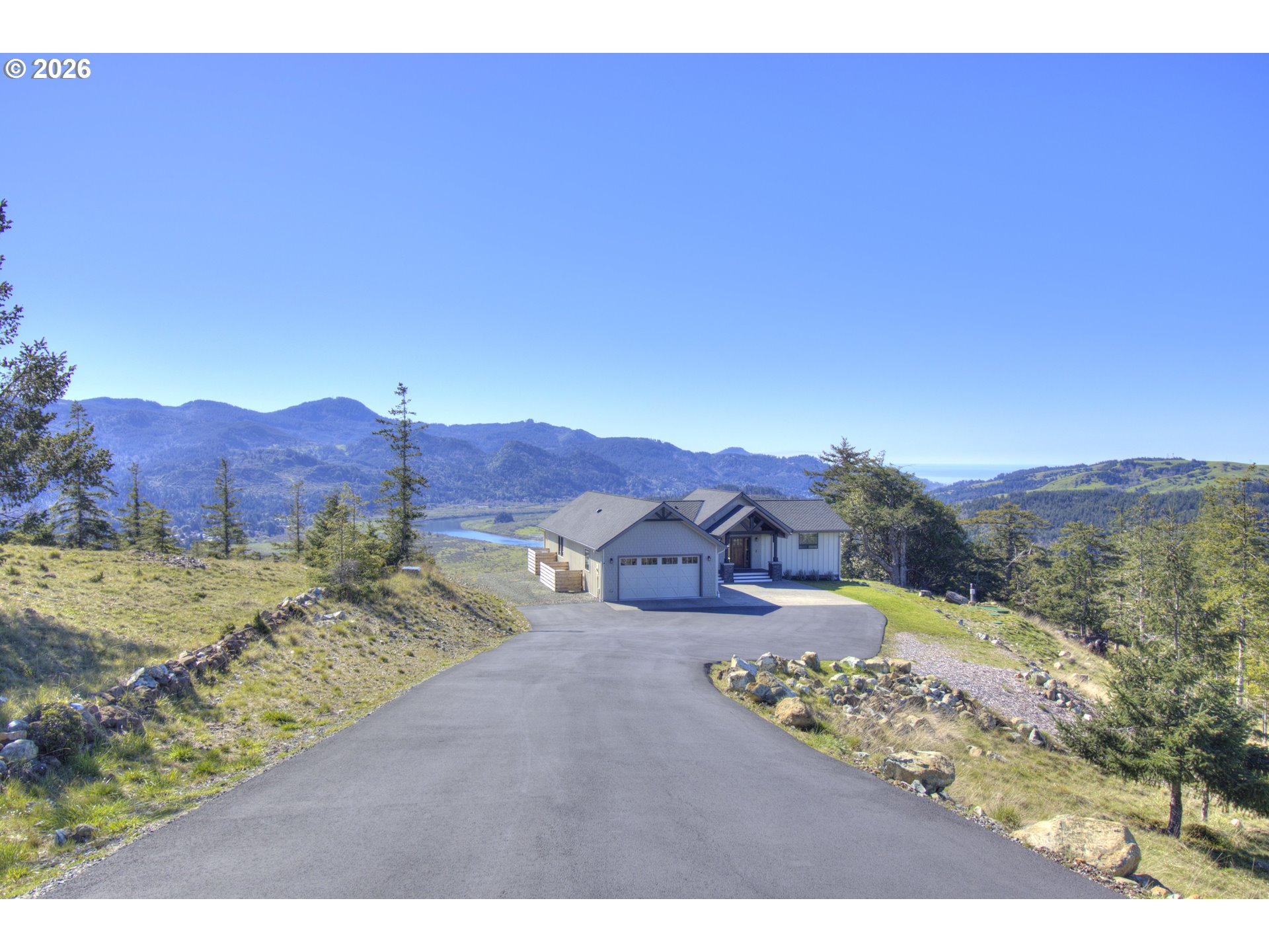 a view of a house with a yard and mountain
