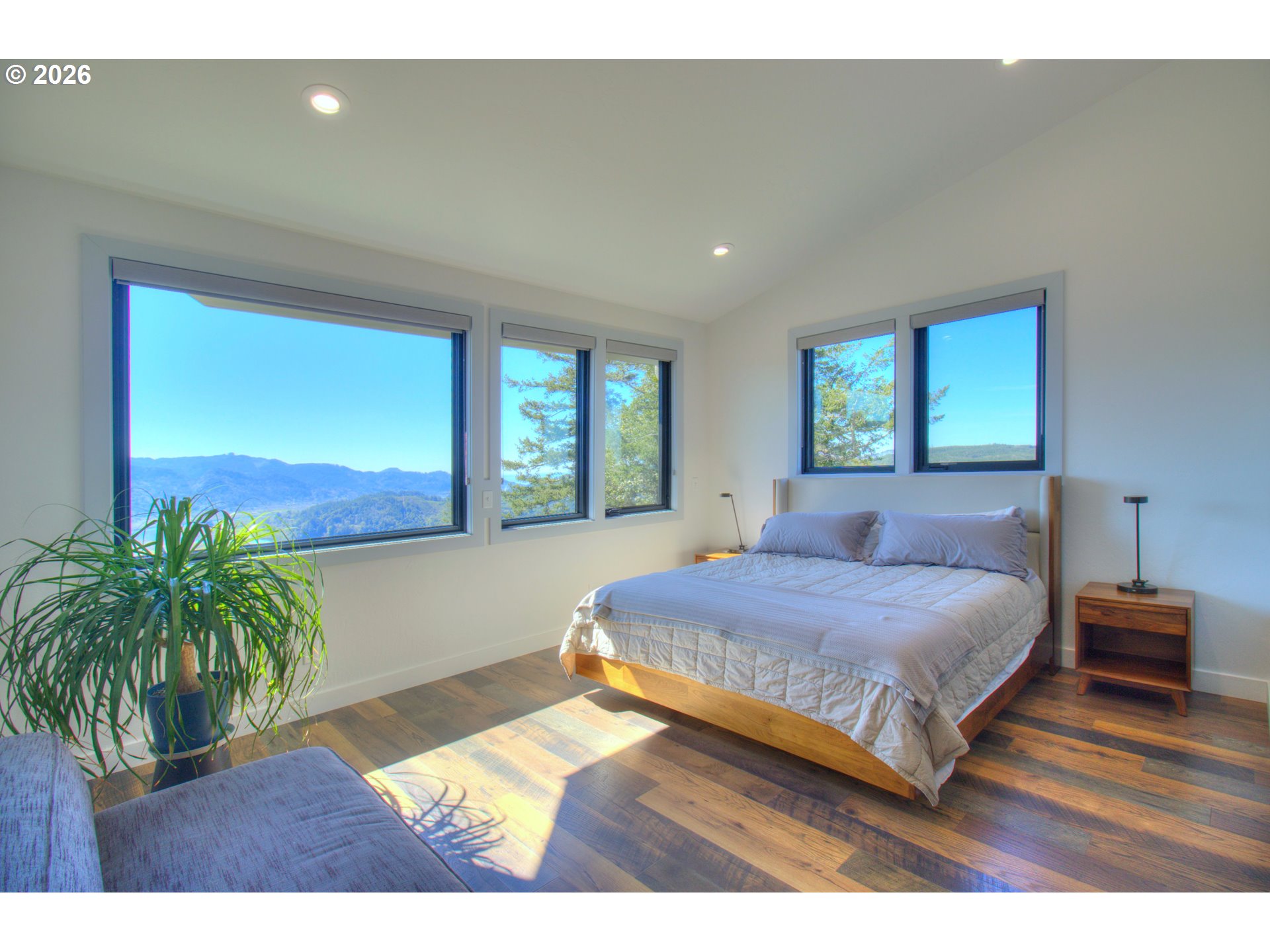 95660 Spirit Ridge Road Gold Beach, OR 97444 - Photo 15 of 34 a bedroom with a bed and a large window