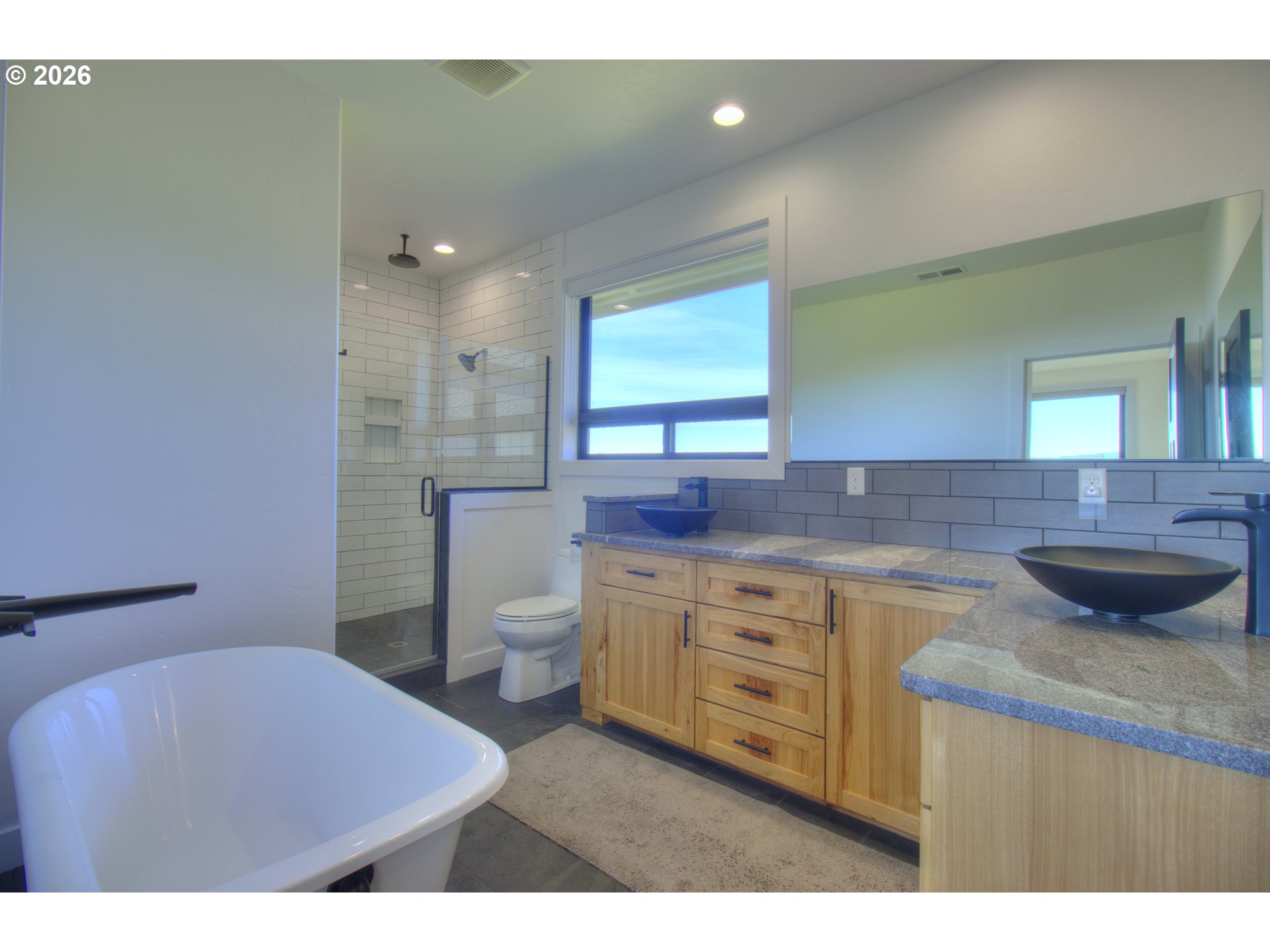95660 Spirit Ridge Road Gold Beach, OR 97444 - Photo 18 of 34 a bathroom with a granite countertop sink a toilet and a mirror