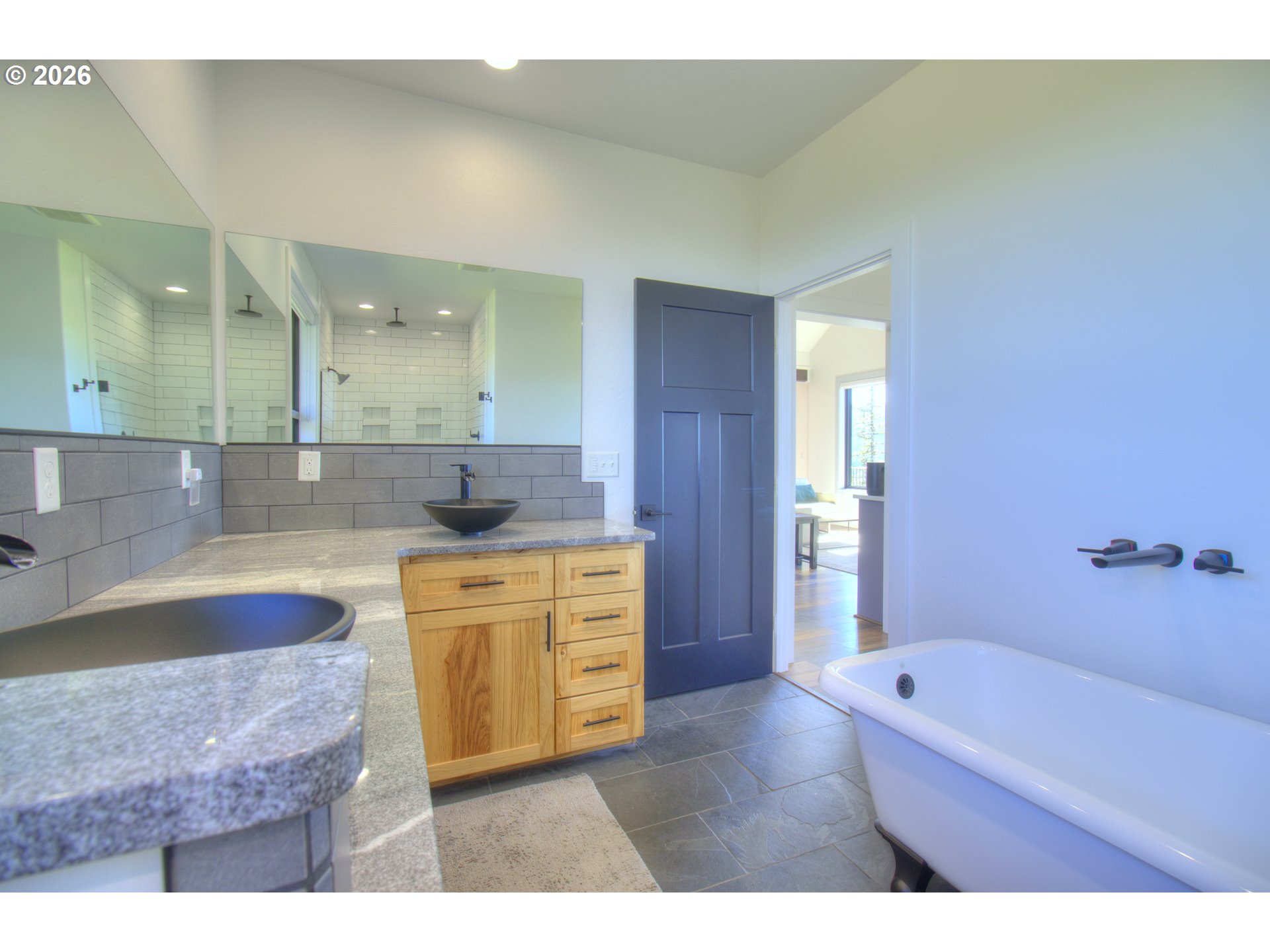 95660 Spirit Ridge Road Gold Beach, OR 97444 - Photo 19 of 34 a bathroom with a granite countertop tub sink and mirror
