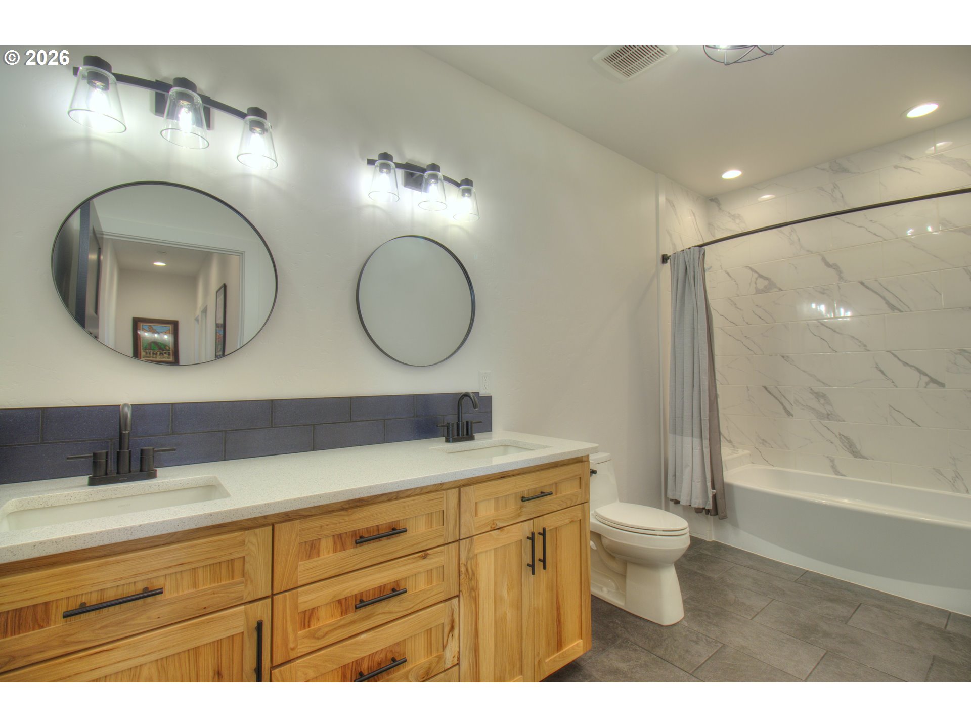95660 Spirit Ridge Road Gold Beach, OR 97444 - Photo 22 of 34 a bathroom with a toilet a double vanity sink and a mirror