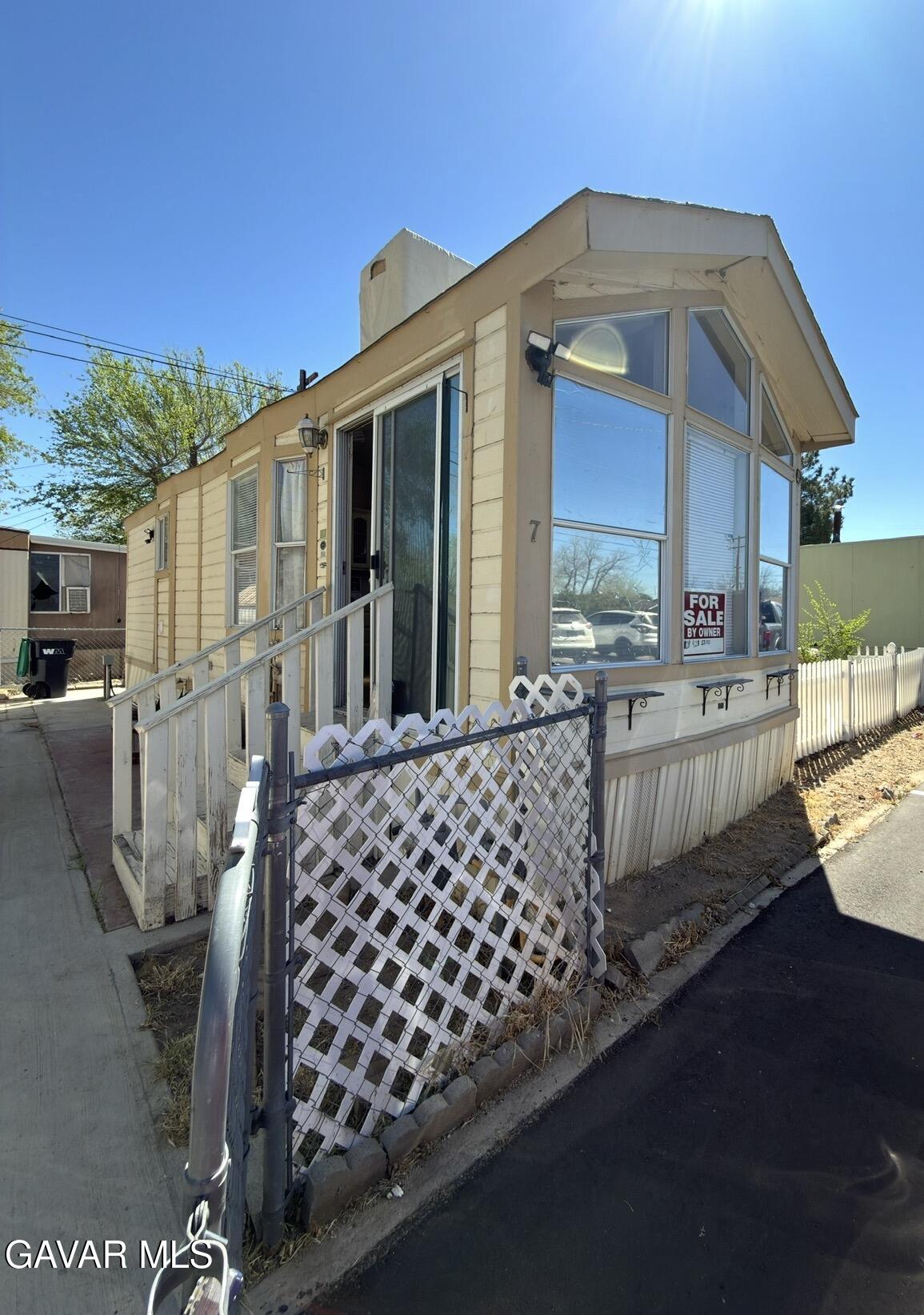 a front view of a house with glass top table and chairs