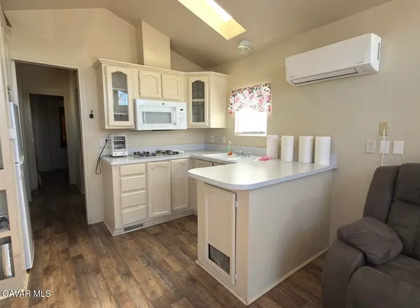a kitchen with a sink cabinets and wooden floor