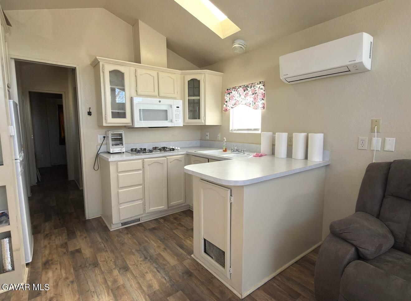 45446 7th Street East Lancaster, CA 93535 - Photo 6 of 6 a kitchen with a sink cabinets and wooden floor