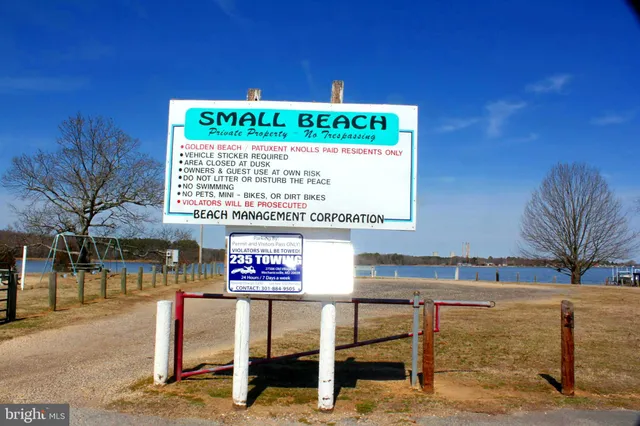a view of a swimming pool with a lawn chairs under an umbrella