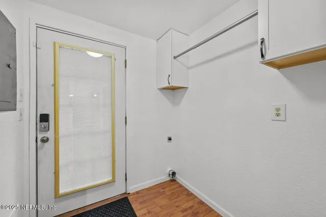 a view of room with window and wooden floor