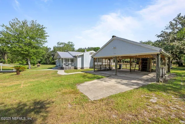 a front view of a house with yard porch and furniture
