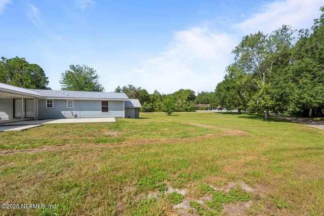 a front view of house with yard space and swimming pool