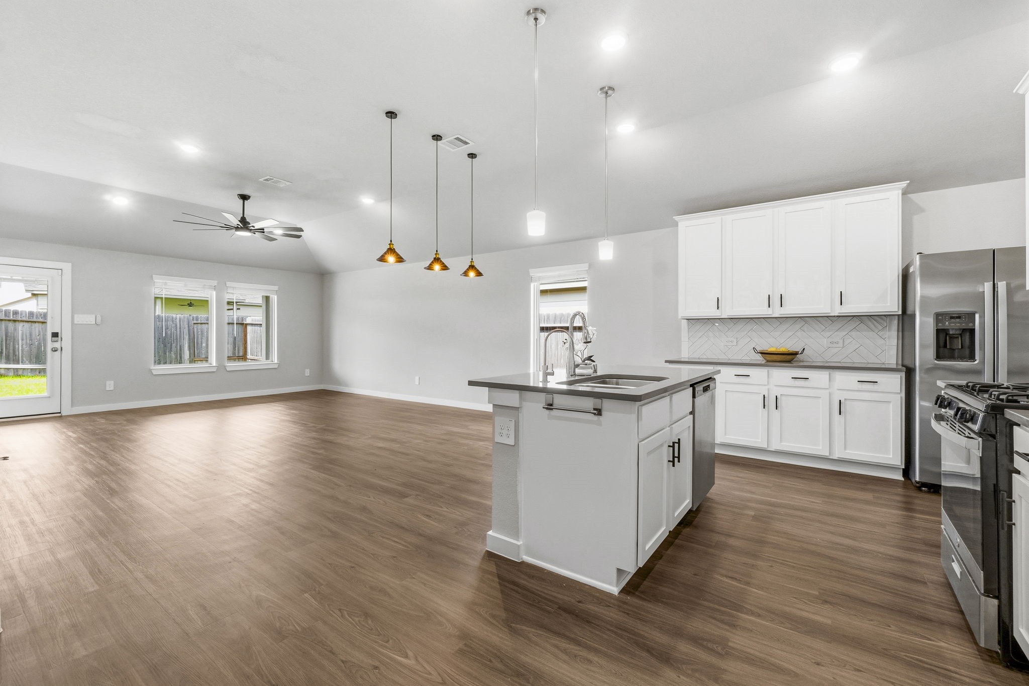 22235 Cardinal Crest Lane New Caney, TX 77357 - Photo 40 of 41 Open-concept floor plan designed for effortless entertaining, featuring a seamless flow between the kitchen, dining, and family room, perfect for gatherings with family and friends.