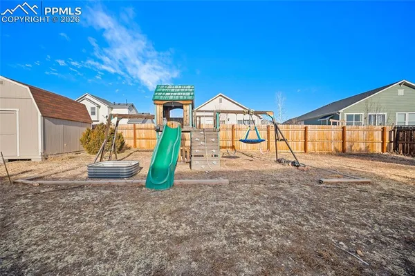 a view of a house with a yard and sitting area