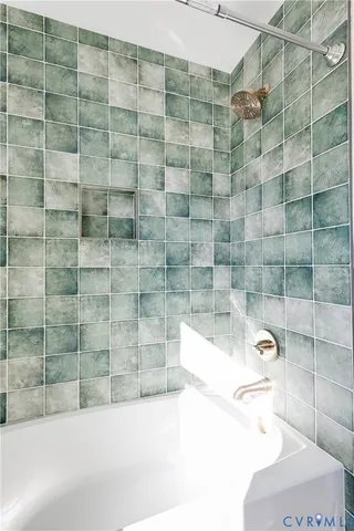 a bathroom with a bathtub and shower
