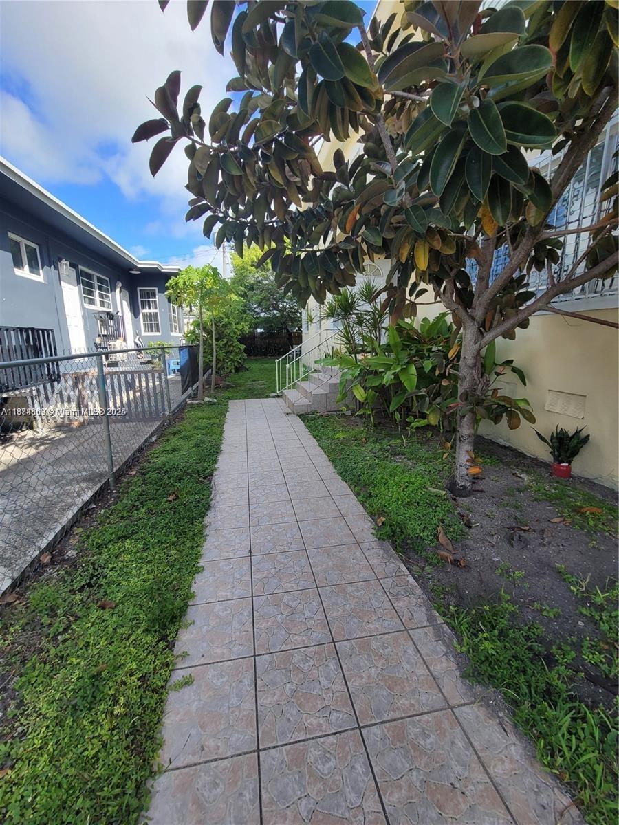 895 80th Street, Unit C Miami Beach, FL 33141 - Photo 3 of 4 a view of a pathway with a tree