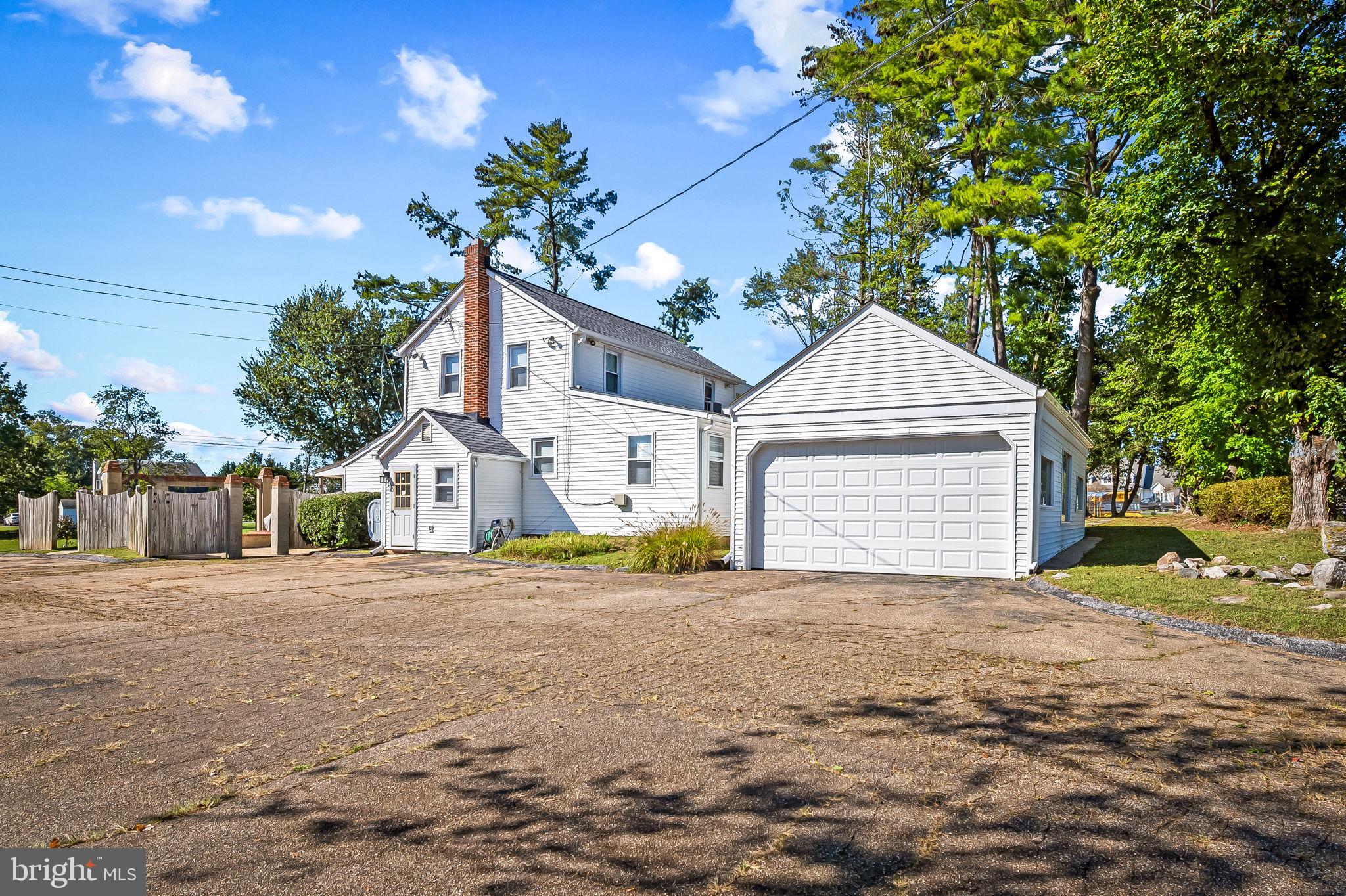 315 Brick Church Road Davidsonville, MD 21035 - Photo 2 of 45 a front view of a house with a yard and garage