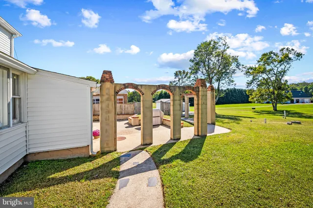a view of a house with a backyard