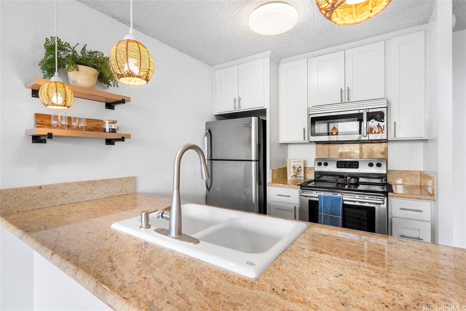 a kitchen with stainless steel appliances granite countertop a sink and a stove