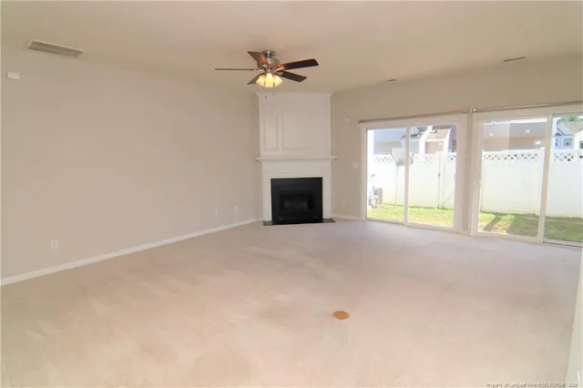 a view of an empty room with a fireplace