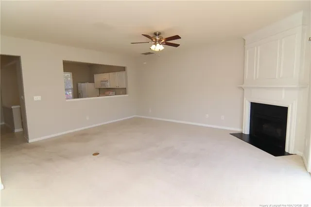 a view of empty room with fireplace
