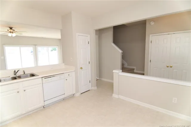 a room with a white bed desk and chair