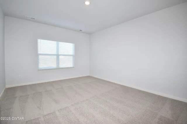 a view of a bathroom with toilet windows and wooden floor