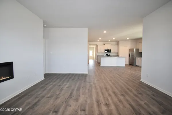 a view of a kitchen with a sink and a refrigerator