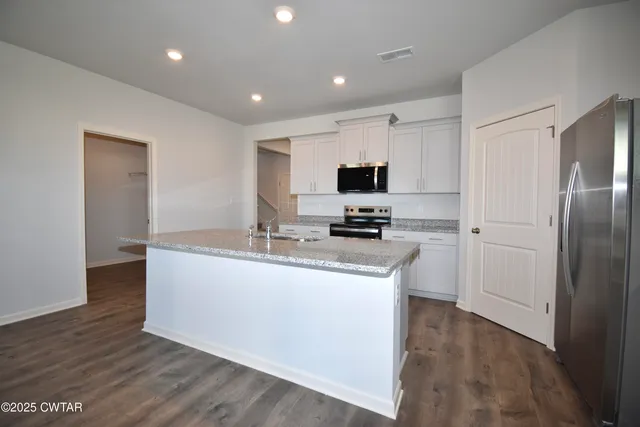a view of a kitchen cabinets and a wooden floor