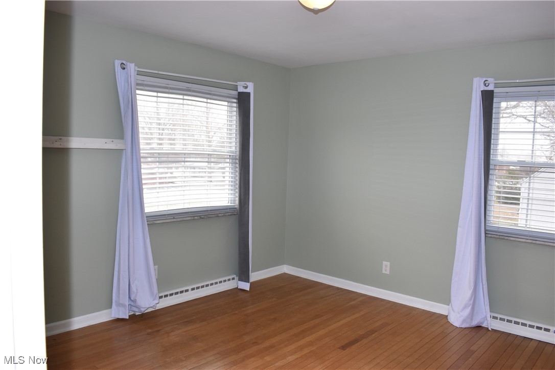 525 Harding Road Zanesville, OH 43701 - Photo 10 of 22 Empty room with a wealth of natural light and a baseboard radiator