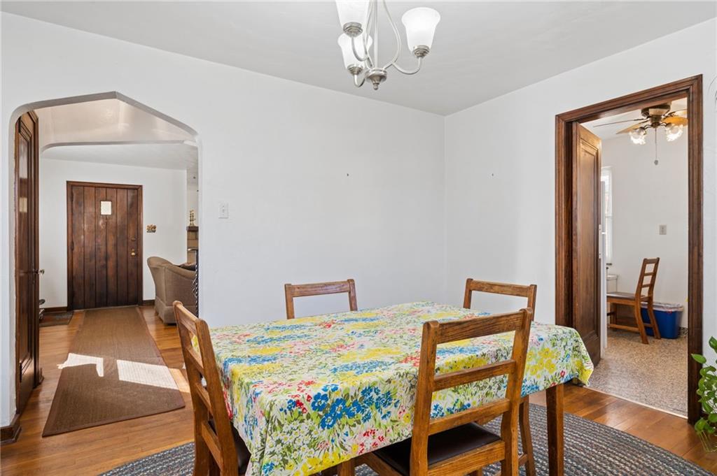 317 Raymond Street Pittsburgh, PA 15218 - Photo 12 of 36 a bedroom with a bed and wooden floor