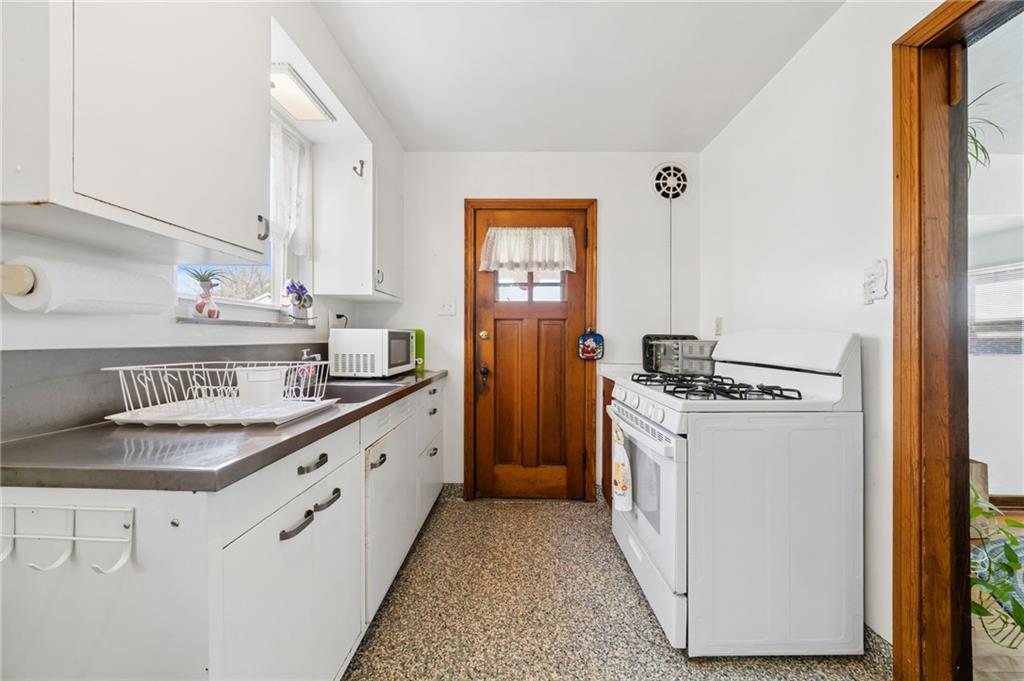 317 Raymond Street Pittsburgh, PA 15218 - Photo 13 of 36 a kitchen with granite countertop a sink stove and refrigerator