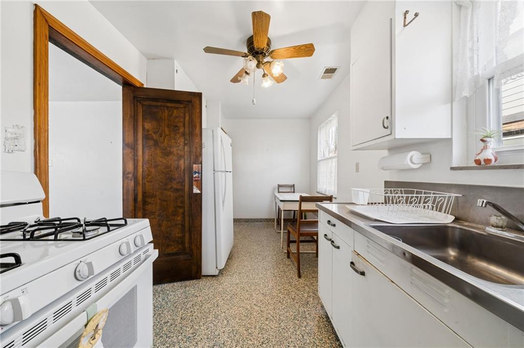 317 Raymond Street Pittsburgh, PA 15218 - Photo 14 of 36 a kitchen with a sink stove and refrigerator