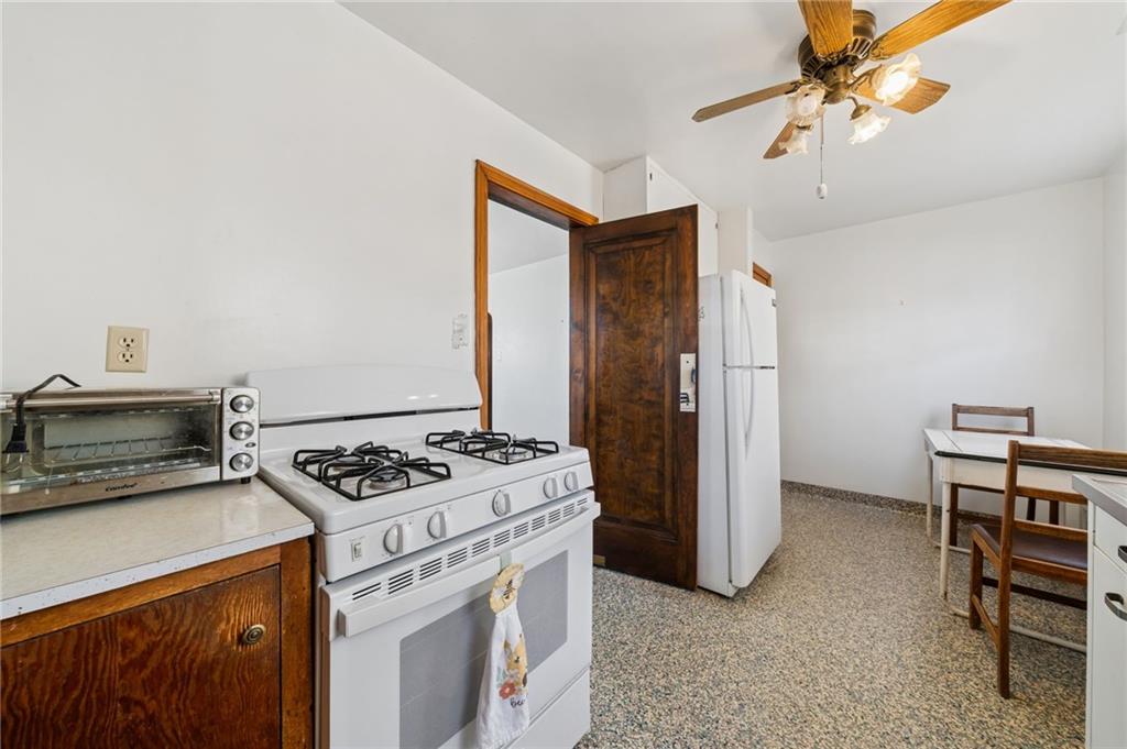 317 Raymond Street Pittsburgh, PA 15218 - Photo 16 of 36 a kitchen with stainless steel appliances granite countertop a stove and a refrigerator