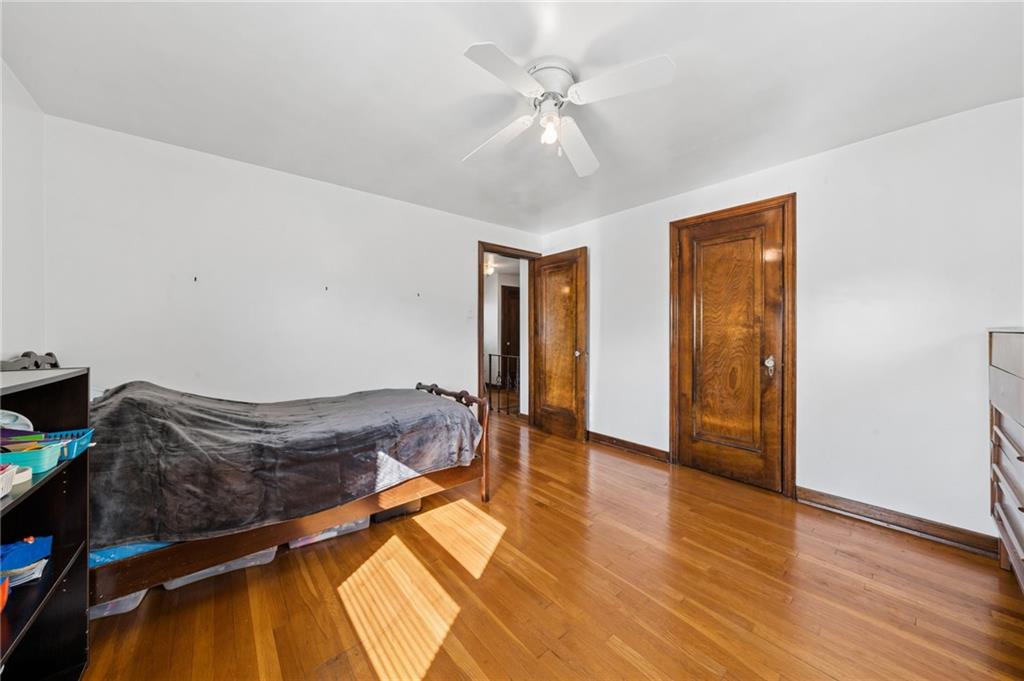 317 Raymond Street Pittsburgh, PA 15218 - Photo 22 of 36 a spacious bedroom with a bed and a chandelier