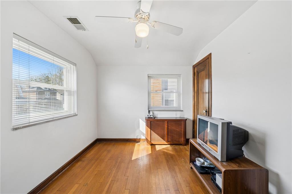 317 Raymond Street Pittsburgh, PA 15218 - Photo 23 of 36 a view of a livingroom with wooden floor and a ceiling fan