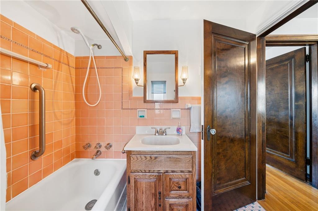 317 Raymond Street Pittsburgh, PA 15218 - Photo 25 of 36 a bathroom with a granite countertop sink mirror bathtub and shower