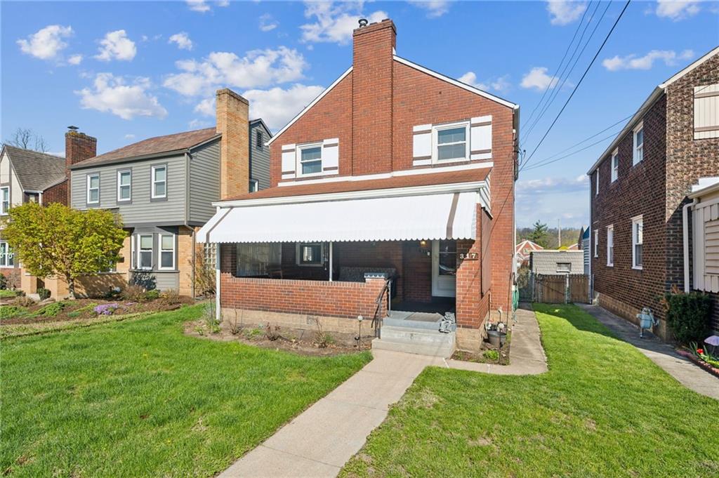 317 Raymond Street Pittsburgh, PA 15218 - Photo 3 of 36 a front view of a house with a yard