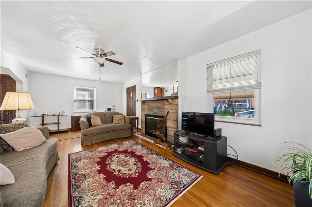 317 Raymond Street Pittsburgh, PA 15218 - Photo 7 of 36 a living room with furniture flat screen tv and a fireplace