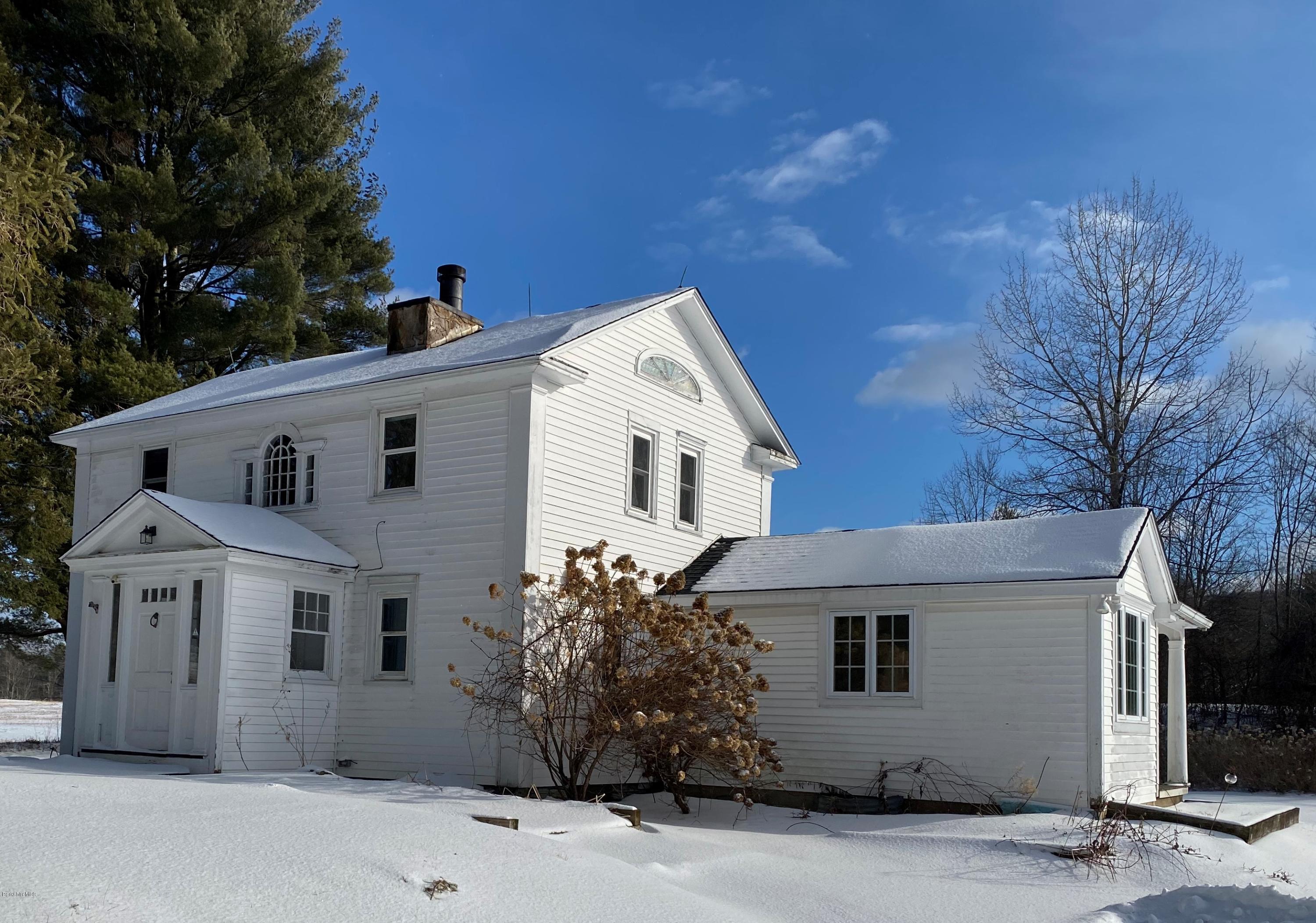 a view of white house with a yard and garage